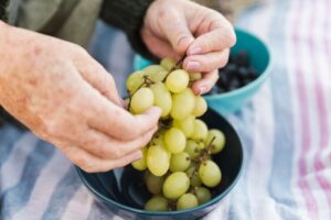 hands holding fresh grapes 23 2148441978