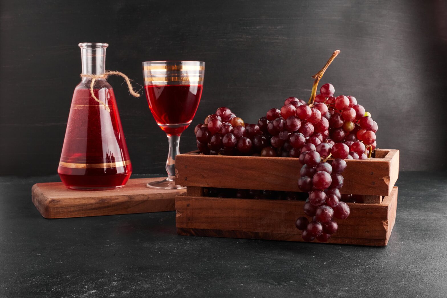 red grape bunches wooden tray with glass wine black min